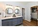 This primary bathroom features a double vanity, walk-in closet and updated finishes at 7413 Misty Woods Ln, Indianapolis, IN 46237