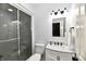 Well-lit bathroom with glass-enclosed shower, vanity with sink, and modern fixtures at 7413 Misty Woods Ln, Indianapolis, IN 46237