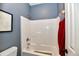 Bathroom with a bathtub and white tiling at 7413 Misty Woods Ln, Indianapolis, IN 46237