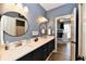 Well-lit bathroom with dual sinks, modern fixtures, and neutral color palette at 7413 Misty Woods Ln, Indianapolis, IN 46237