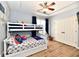 bedroom with twin bunk bed, closet, and hardwood floors at 7413 Misty Woods Ln, Indianapolis, IN 46237
