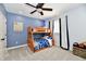 Nicely styled bedroom featuring a ceiling fan, bunk bed, and window with curtains at 7413 Misty Woods Ln, Indianapolis, IN 46237