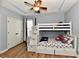 Stylish bedroom featuring a unique bunk bed with built-in stairs and storage, perfect for  at 7413 Misty Woods Ln, Indianapolis, IN 46237