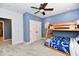 Blue and gray bedroom with a ceiling fan and a wooden bunk bed featuring team-themed sheets at 7413 Misty Woods Ln, Indianapolis, IN 46237