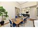Dining room featuring a wooden table with blue chairs and a modern chandelier at 7413 Misty Woods Ln, Indianapolis, IN 46237