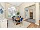 Dining room with a large window, chandelier, and wooden table with blue chairs at 7413 Misty Woods Ln, Indianapolis, IN 46237