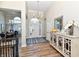 Elegant foyer with hardwood floors, chandelier lighting, and a glimpse into the dining room at 7413 Misty Woods Ln, Indianapolis, IN 46237