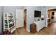 Hallway with built in shelving unit, dresser, and open door leading to bedroom at 7413 Misty Woods Ln, Indianapolis, IN 46237