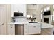 Stylish kitchen featuring stainless steel appliances, white cabinets, and a sink with a black faucet at 7413 Misty Woods Ln, Indianapolis, IN 46237