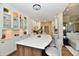 Bright kitchen with white cabinets and a large island with seating for casual dining at 7413 Misty Woods Ln, Indianapolis, IN 46237