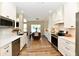Bright kitchen with white cabinets, stainless steel appliances, and a center island with seating at 7413 Misty Woods Ln, Indianapolis, IN 46237