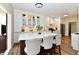 Bright kitchen with white cabinets, a large island with seating, and stainless steel appliances at 7413 Misty Woods Ln, Indianapolis, IN 46237