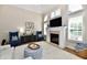 Bright living room featuring a fireplace, shutters, and comfortable seating at 7413 Misty Woods Ln, Indianapolis, IN 46237