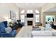 Bright living room with a fireplace, large windows, and comfortable seating area at 7413 Misty Woods Ln, Indianapolis, IN 46237