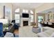 Bright living room featuring a fireplace, shuttered windows, and plush seating at 7413 Misty Woods Ln, Indianapolis, IN 46237