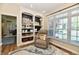 Charming living room with a comfortable recliner, built-in bookcase, and stylish decor at 7413 Misty Woods Ln, Indianapolis, IN 46237