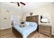 This spacious primary bedroom has a beautiful headboard, dresser, and wood-look floors at 7413 Misty Woods Ln, Indianapolis, IN 46237