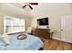 A beautiful primary bedroom is decorated with modern furniture and a mounted television at 7413 Misty Woods Ln, Indianapolis, IN 46237