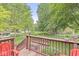 A cozy wood deck features seating and a view of the fenced yard at 7616 E Concord Ln, Fishers, IN 46038