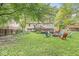 Expansive backyard featuring a lush lawn, a fire pit, and a multi-level deck, creating an inviting outdoor space at 7616 E Concord Ln, Fishers, IN 46038