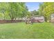 Expansive backyard featuring a lush lawn, a fire pit, and mature trees, creating an inviting outdoor space at 7616 E Concord Ln, Fishers, IN 46038