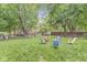 Expansive backyard featuring a lush lawn, a fire pit, and mature trees, creating an inviting outdoor space at 7616 E Concord Ln, Fishers, IN 46038