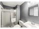 Modern bathroom with a glass-enclosed shower, vanity, and mirror offers a clean and functional space at 7616 E Concord Ln, Fishers, IN 46038