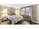 This bedroom features hardwood floors and two windows offering natural light at 7616 E Concord Ln, Fishers, IN 46038