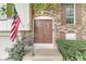 Close-up of the front entrance, highlighting the brickwork, the double-door entry and an American flag at 7616 E Concord Ln, Fishers, IN 46038