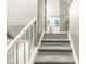 Carpeted staircase leading up to a bright landing area at 7616 E Concord Ln, Fishers, IN 46038