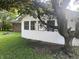 Cozy backyard showcasing home's exterior, shade tree, and green lawn at 7721 Hollybrook Ln, Indianapolis, IN 46227