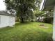 Large backyard features green lawn, privacy fence, and detached garage at 7721 Hollybrook Ln, Indianapolis, IN 46227