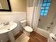 Cozy bathroom featuring a pedestal sink and a shower at 7721 Hollybrook Ln, Indianapolis, IN 46227