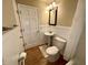 Bathroom featuring a toilet and pedestal sink at 7721 Hollybrook Ln, Indianapolis, IN 46227