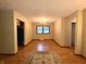 Open dining room with wood floors, a window, a chandelier, and a decorative rug at 7721 Hollybrook Ln, Indianapolis, IN 46227