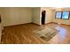 Open dining room with wood floors, access to kitchen, natural light, and a decorative rug at 7721 Hollybrook Ln, Indianapolis, IN 46227