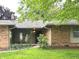 Attractive brick home featuring a cozy covered porch at 7721 Hollybrook Ln, Indianapolis, IN 46227