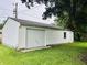Exterior view of the detached one-car garage with white siding and green grass at 7721 Hollybrook Ln, Indianapolis, IN 46227