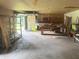 Spacious garage with open door, storage shelves, and work bench, offering ample space for projects and parking at 7721 Hollybrook Ln, Indianapolis, IN 46227