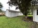 Backyard with detached one-car garage and mature shade tree at 7721 Hollybrook Ln, Indianapolis, IN 46227