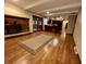 Spacious living room with wood floors, brick fireplace, and access to kitchen and outdoor deck at 7721 Hollybrook Ln, Indianapolis, IN 46227
