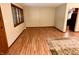 Bright living room features wood floors, a decorative rug, and natural light from the window and front door at 7721 Hollybrook Ln, Indianapolis, IN 46227