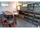 Basement bar featuring warm wood finishes, stylish seating, and accent lights at 828 N Butler Ave, Indianapolis, IN 46219