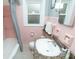 Charming bathroom with pink tile, granite countertop, and vintage fixtures at 828 N Butler Ave, Indianapolis, IN 46219