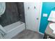 Bathroom with a shower, new faucet, and a gray stone accent wall at 828 N Butler Ave, Indianapolis, IN 46219
