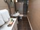 Cozy bathroom featuring tiled floors, pedestal sink, and tiled shower at 828 N Butler Ave, Indianapolis, IN 46219