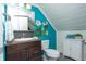 A modern bathroom featuring stylish blue walls and an accent cabinet for extra storage at 828 N Butler Ave, Indianapolis, IN 46219
