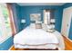 Bright bedroom featuring a large window, plush bedding, and hardwood floors at 828 N Butler Ave, Indianapolis, IN 46219