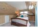 Rustic bedroom with wood paneling, sloped ceilings, and a cozy atmosphere at 828 N Butler Ave, Indianapolis, IN 46219