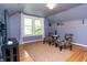 Cozy bonus room featuring hardwood floors, natural light, and comfortable seating at 828 N Butler Ave, Indianapolis, IN 46219